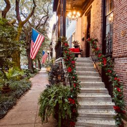 brown brick building with red flowers on the side