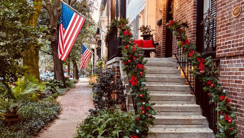 brown brick building with red flowers on the side