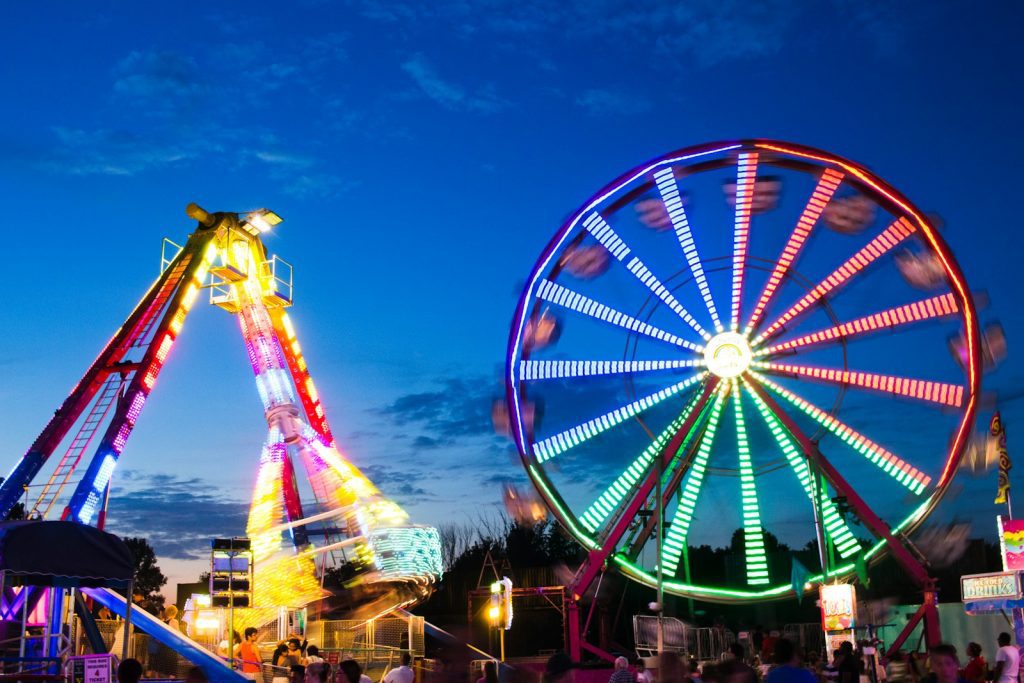 a ferris wheel and a ferris wheel lit up at night at the Forsyth County Fair at Cumming Fair Grounds