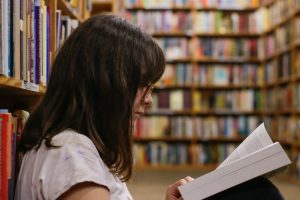 student reading a book in forsyth County schools