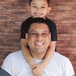 a man holding a young boy on his shoulders in Forsyth County GA