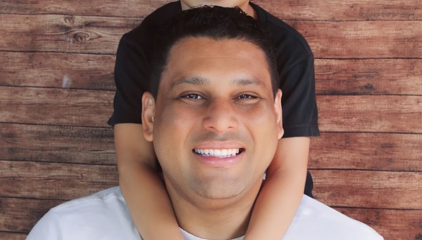 a man holding a young boy on his shoulders in Forsyth County GA