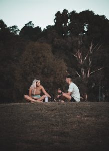 a man and a woman sitting on the ground