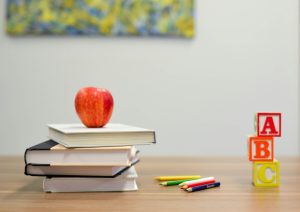 red apple fruit on four pile books