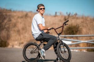 a man riding a bike down a street