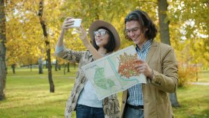 Couple taking a selfie with a map in park