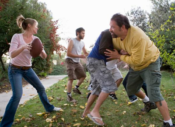 Fun family playing football in Forsyth
