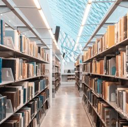 brown wooden book shelves in library