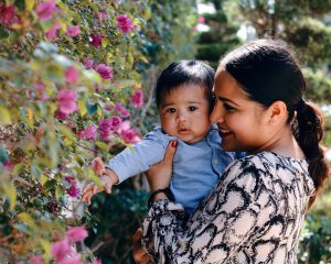 Mother and chile looking at flowers