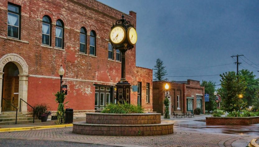 Charming brick building with unique street clock in Wabasha, Minnesota. Urban historic scene at dusk.